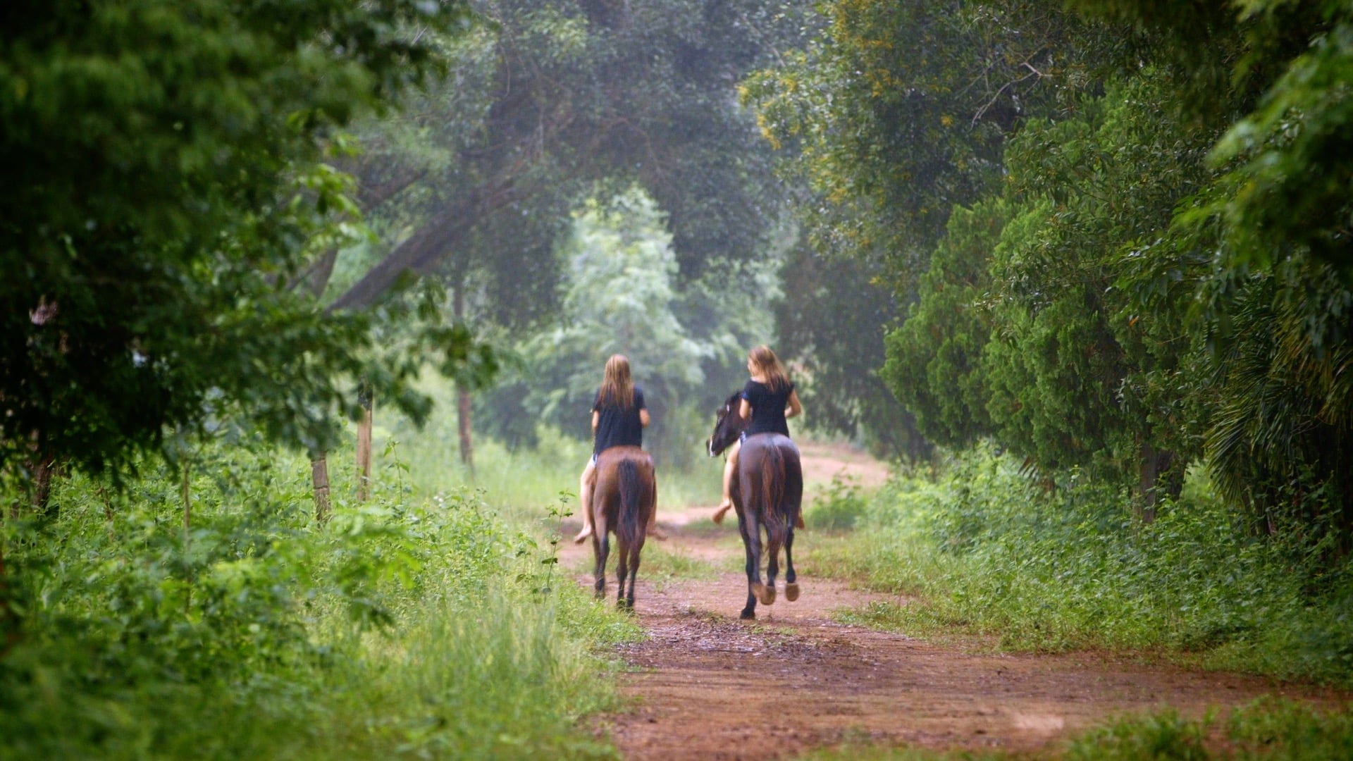 two girls riding horses