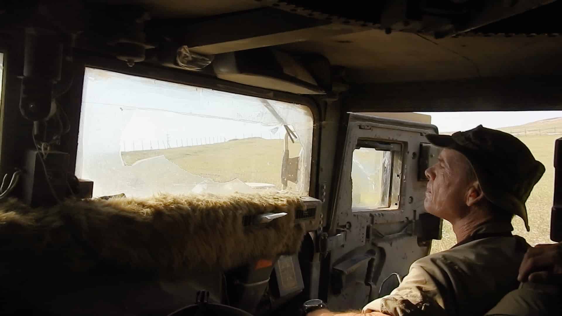 man in military vehicle